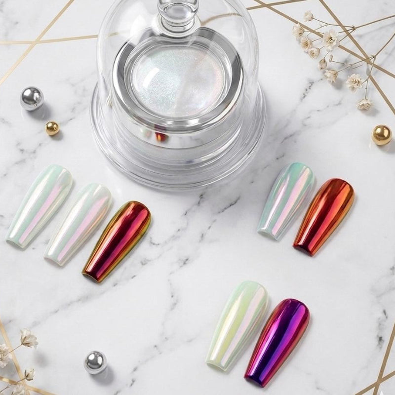 Metallic nail art tips on a marble surface with decorative elements
