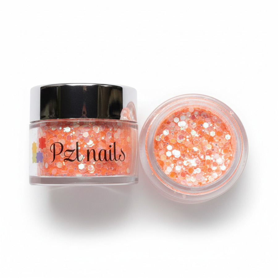 Open container of orange glitter with 'PZT Nails' branding on a white background