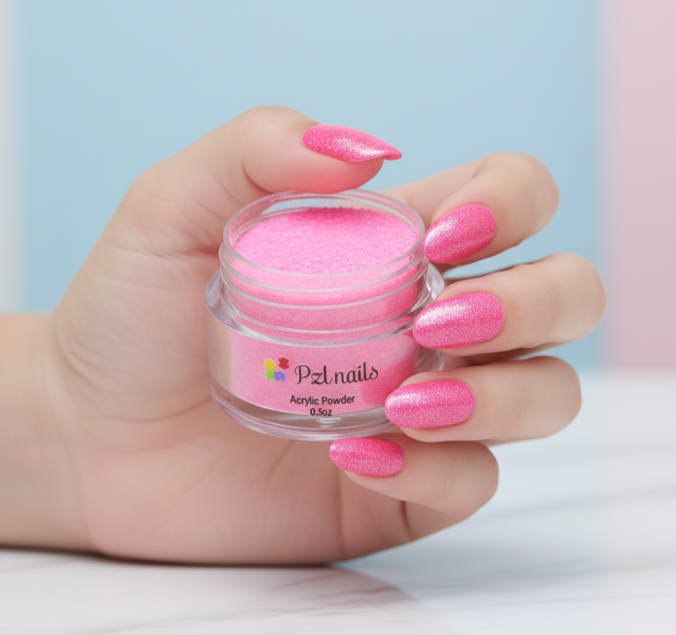 Hand holding a jar of pink acrylic powder with matching nails against a light blue background