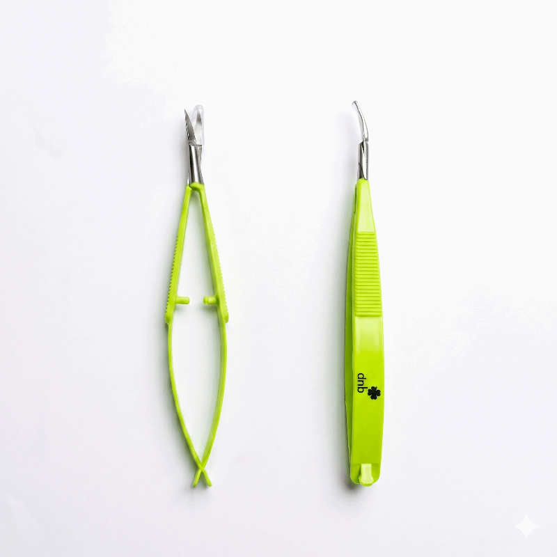 Two green precision scissors on a white background