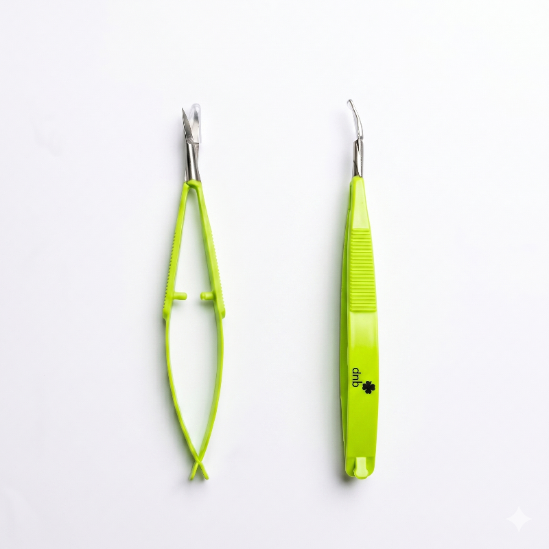 Two green precision scissors on a white background