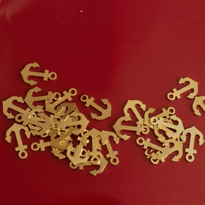 Gold anchor-shaped objects on a red background