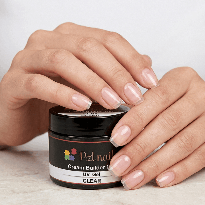 Person applying nail gel to their nails with a jar of PZL nail product.