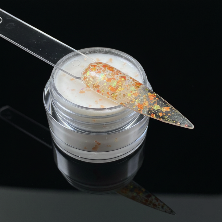 Jar of glitter with a spoonful of glitter on a black background
