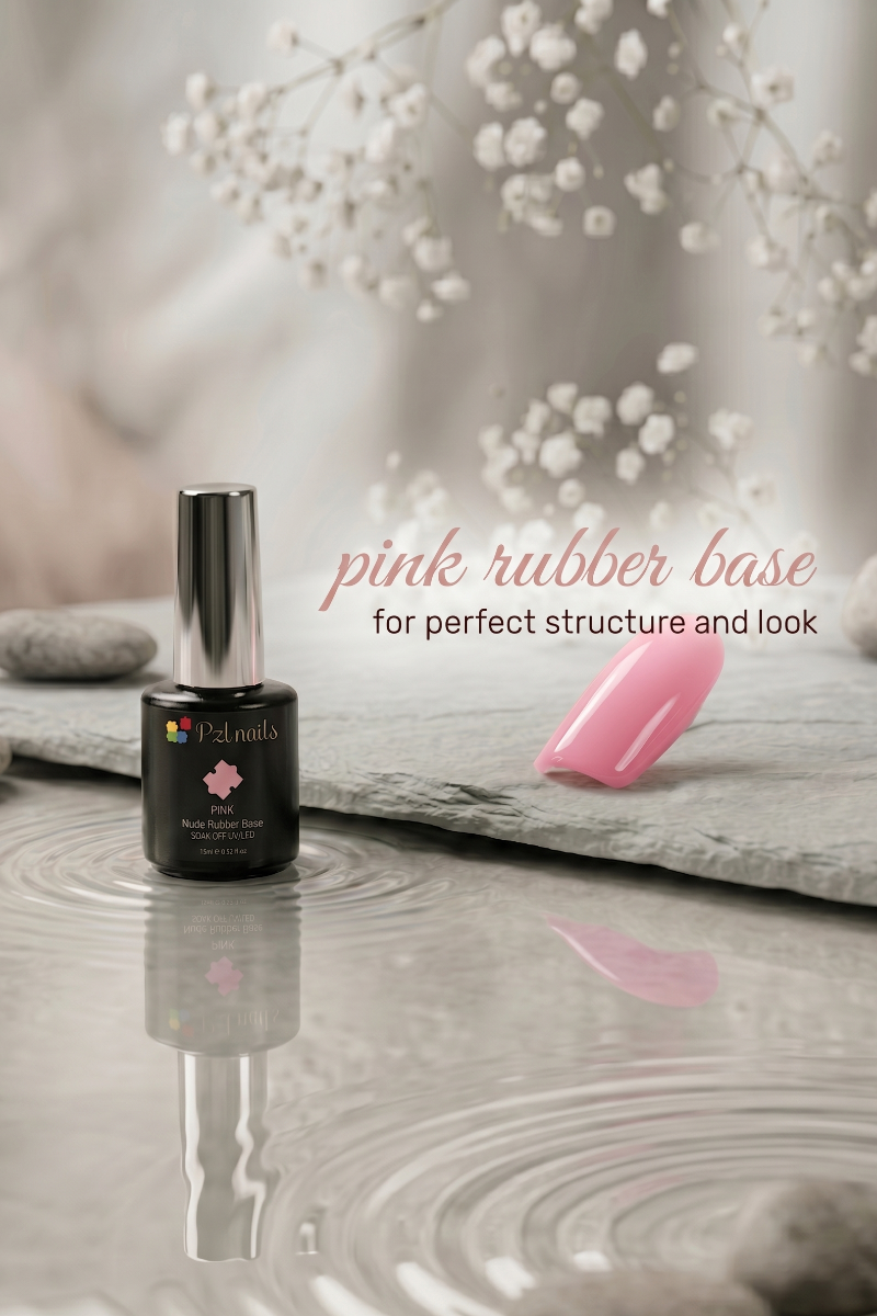 Nail polish bottle with pink rubber base coat on a reflective surface with decorative elements.
