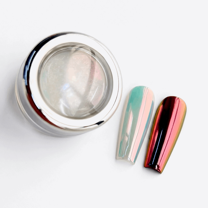 Silver container with a reflective surface next to two colorful nail polish bottles on a light gray background