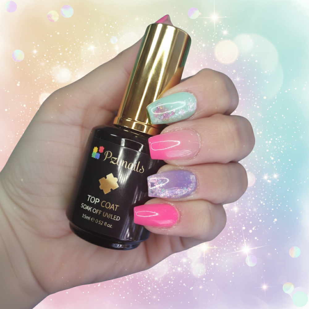 Hand holding a bottle of Pzinals nail polish with colorful nail art on a glittery background